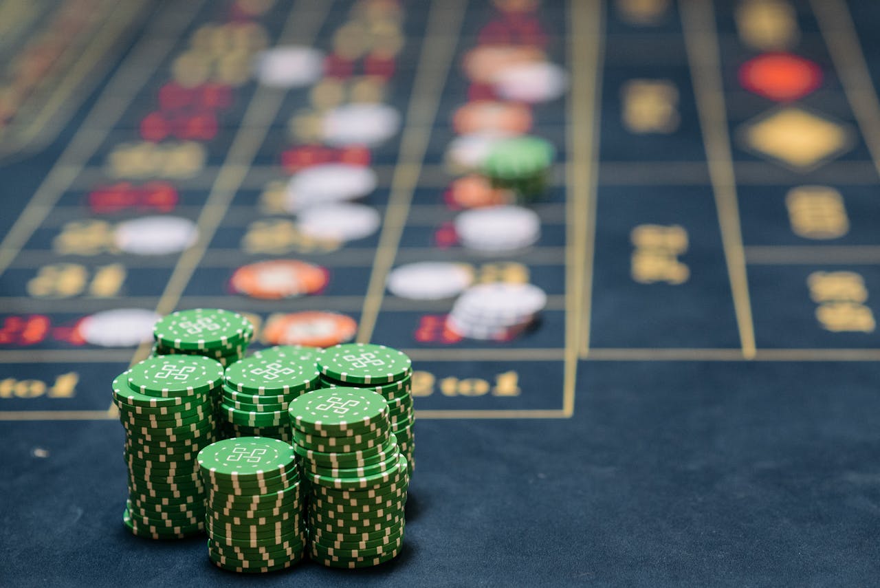 Home Stack of green poker chips on a casino table, highlighting the gambling theme.